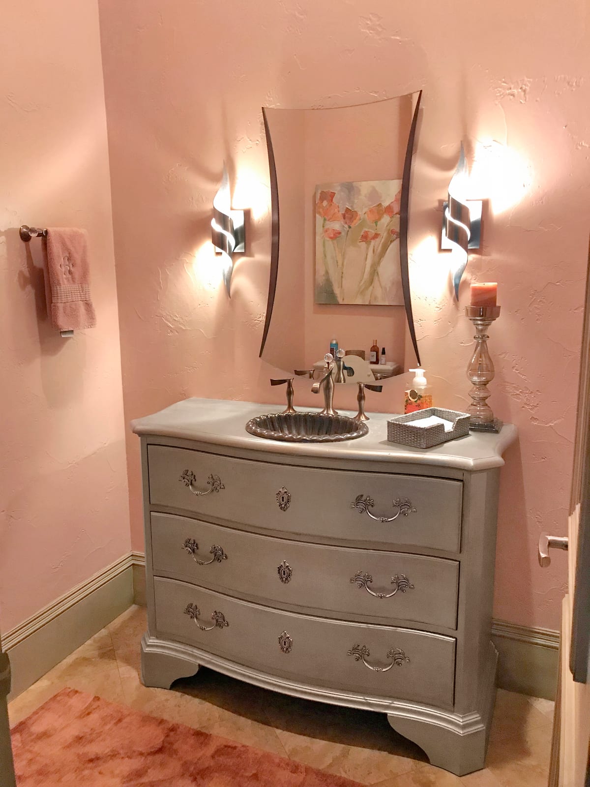 Powder room with antique chest vanity and sconce lighting