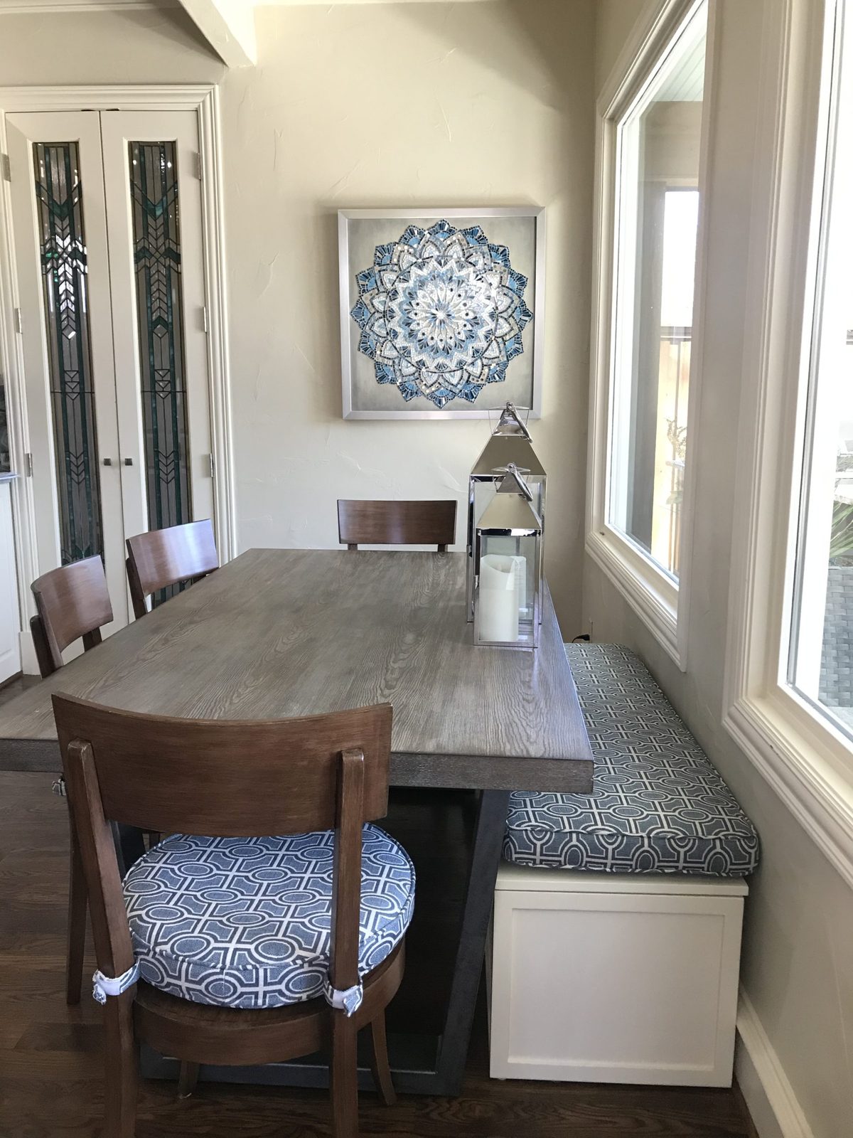 Breakfast nook with a banquette beneath a shaded window