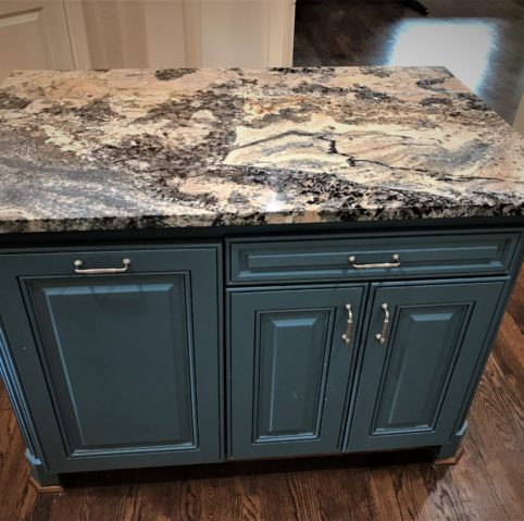 Kitchen island detail with granite counters and pendant lighting