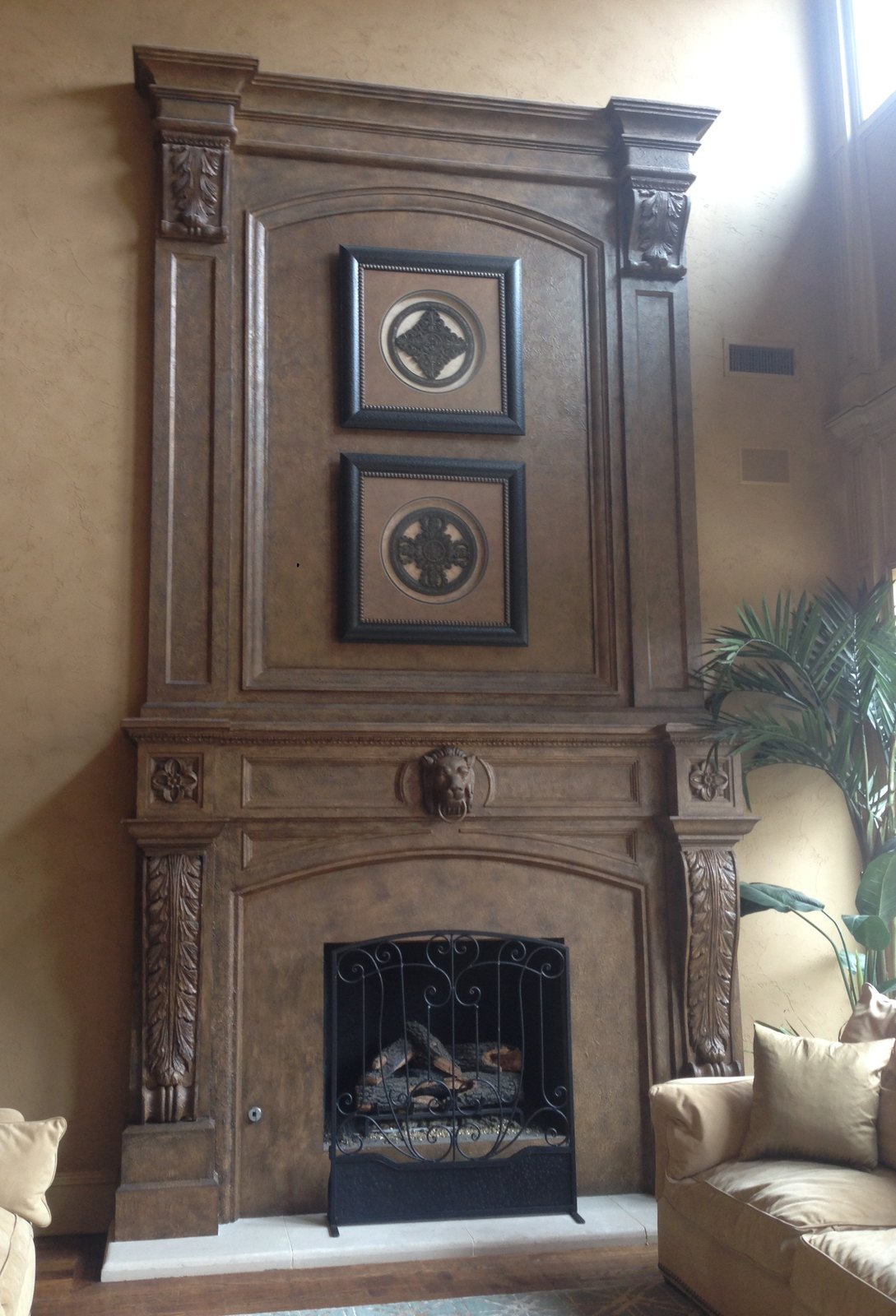 Floor-to-ceiling fireplace in heavy carved dark wood