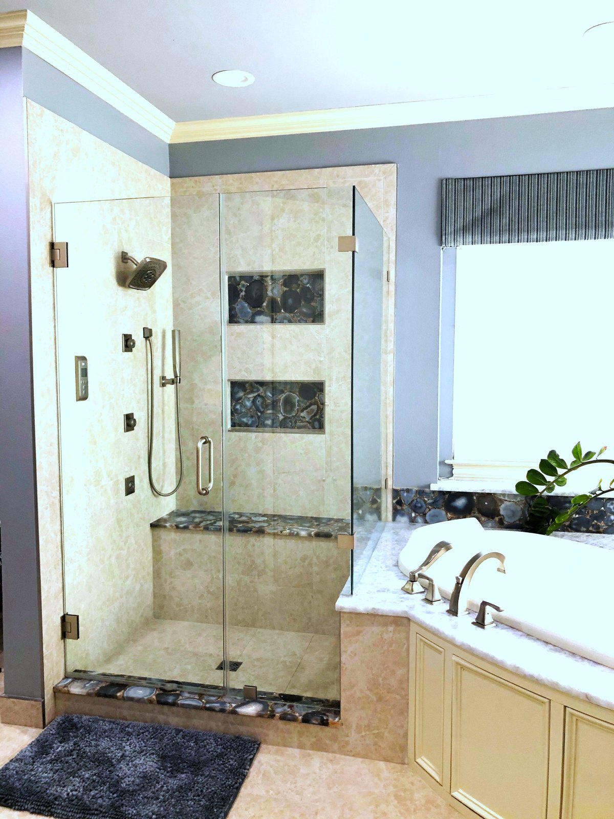 Walk-in shower with agate slice niches beside a soaking tub