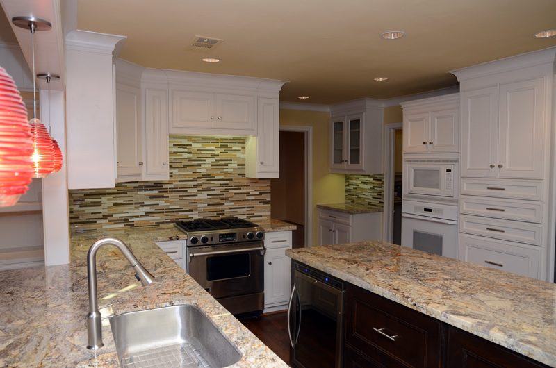 Traditional kitchen with warm cabinetry, granite counters and a large island