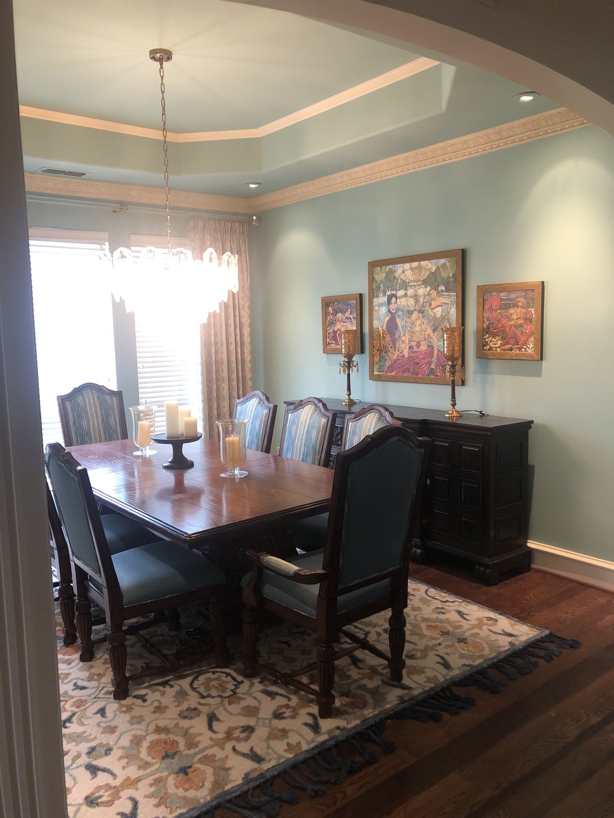 Contemporary dining space with upholstered chairs and a glass table