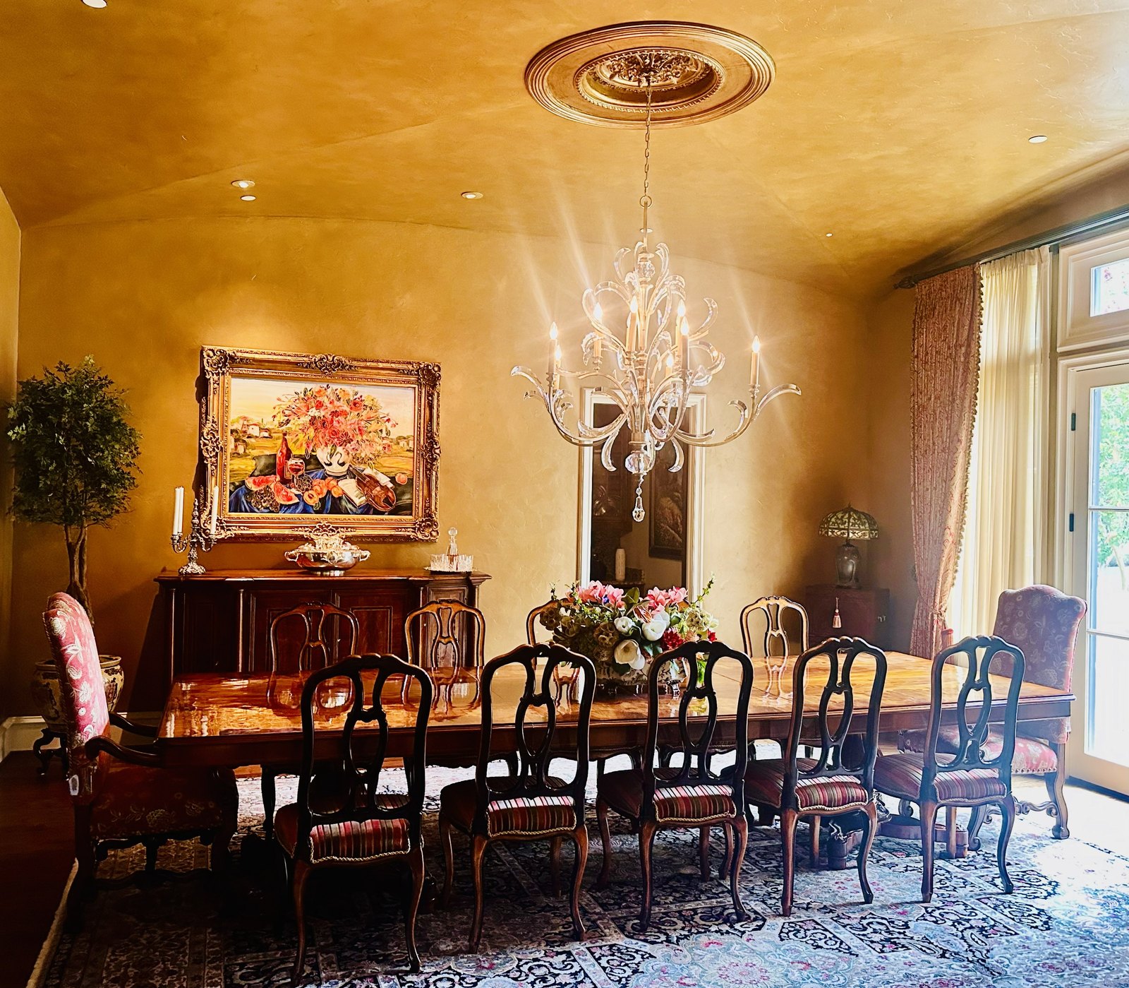 Grand formal dining room with a chandelier designed by Chateau Concepts