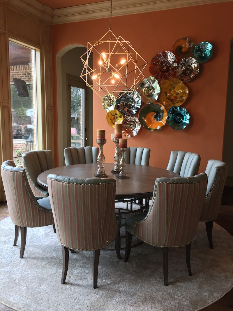 Dining room with a geometric chandelier over a round table