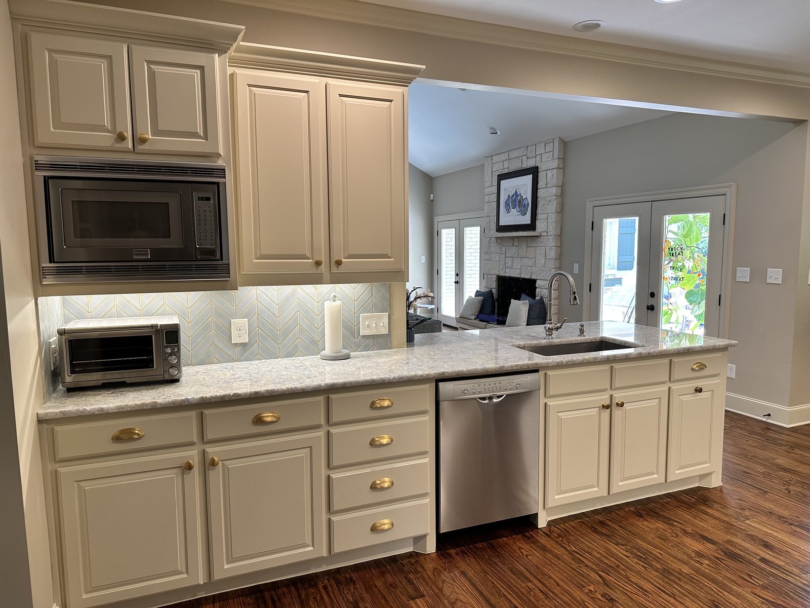 Remodeled Dallas kitchen with a large granite island and a statement chandelier