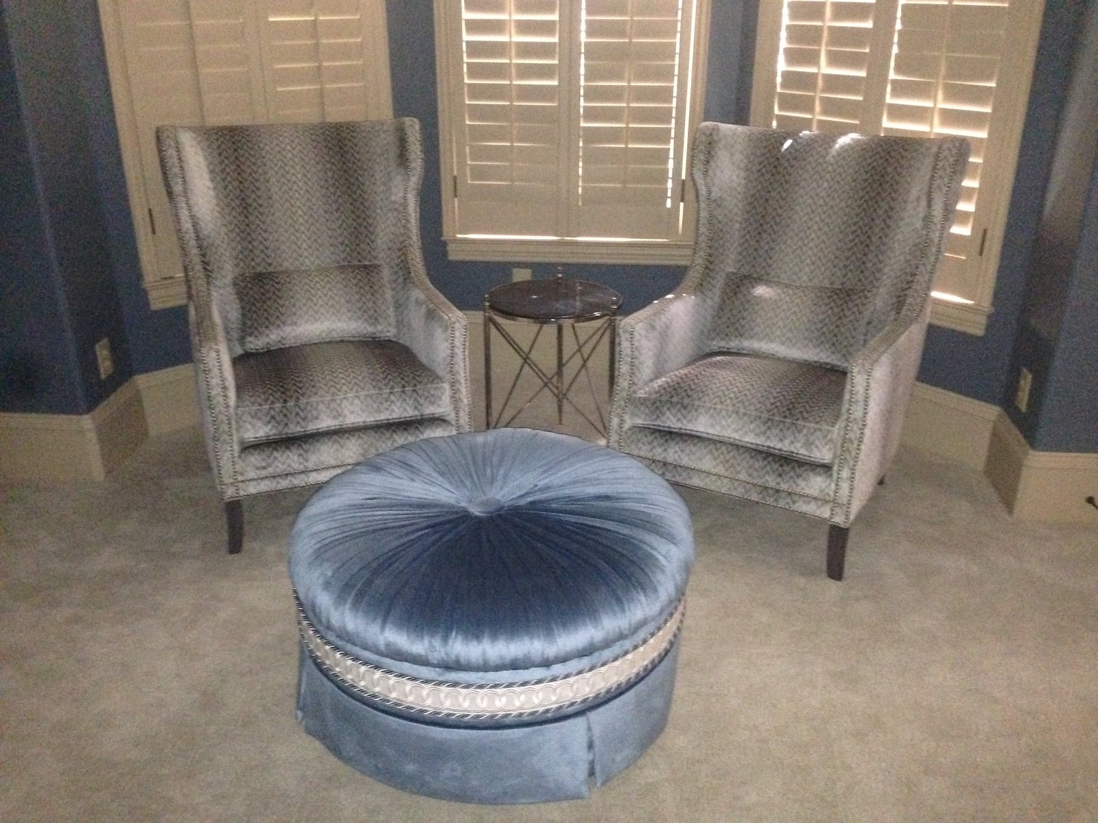 Living room corner with velvet upholstery, custom cushions and a floor lamp