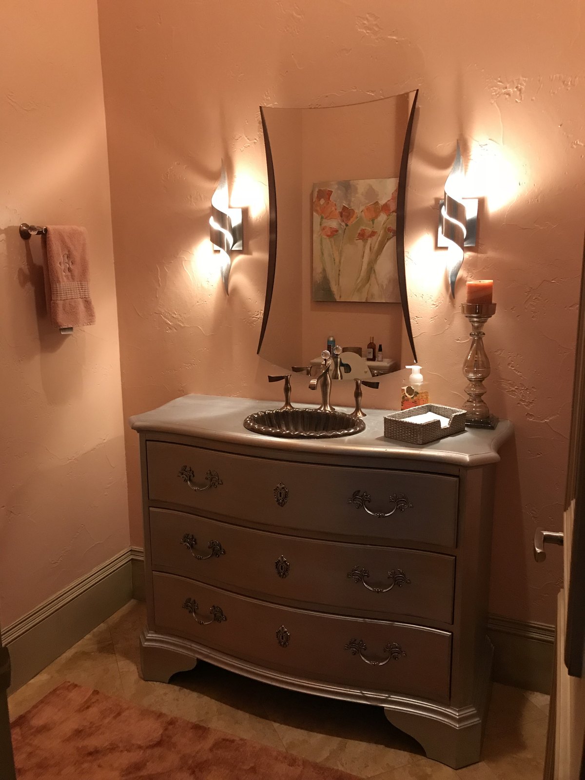Powder room with antique chest vanity and sconce lighting