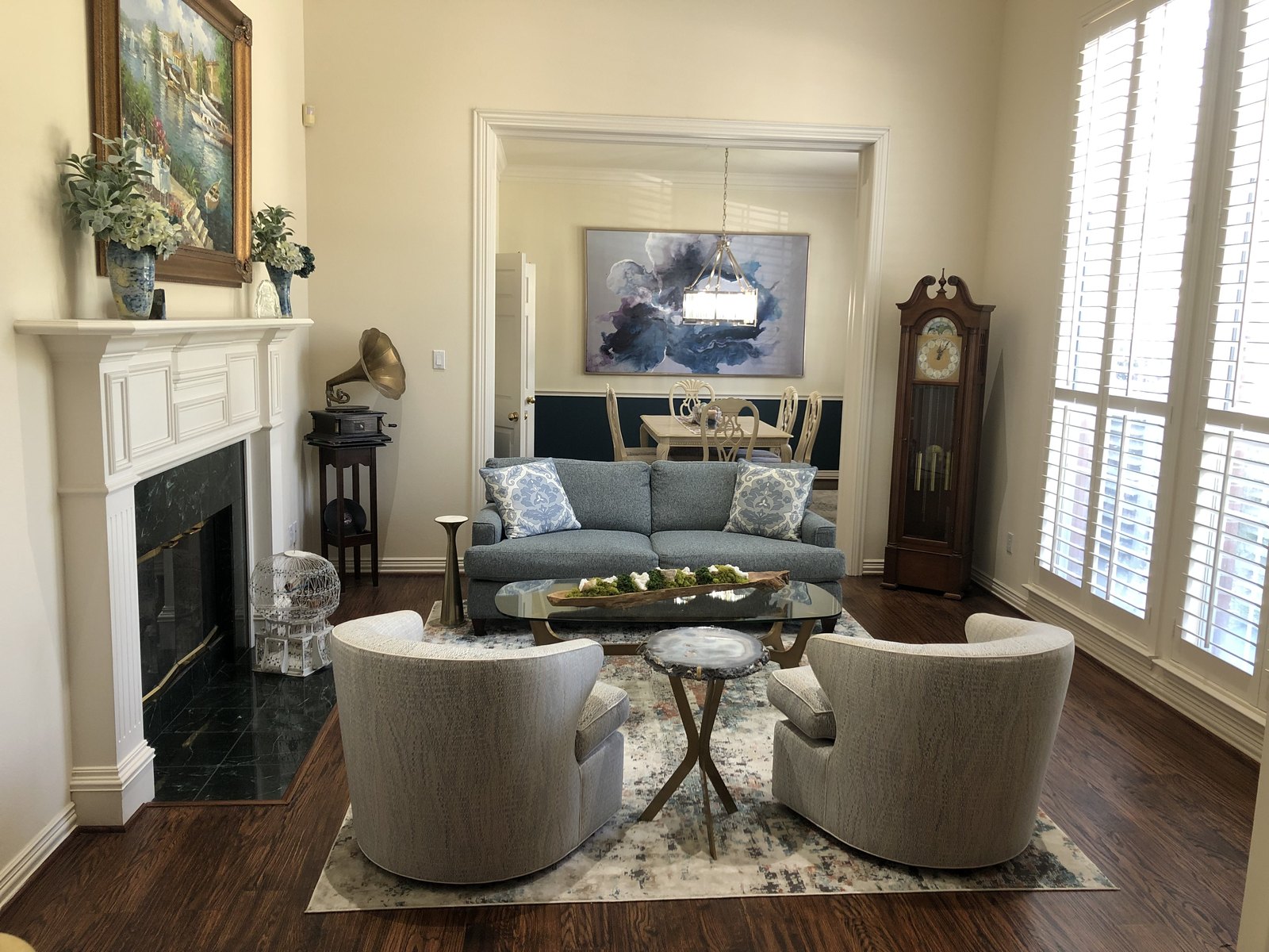 Living room with a large neutral area rug anchoring the seating